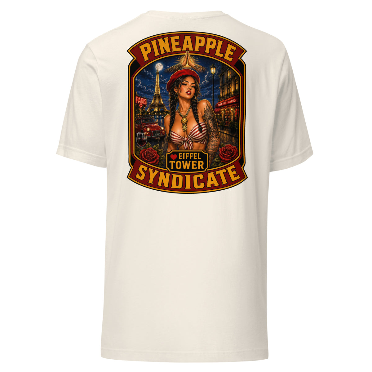 Pineapple Syndicate Eiffel Tower tee featuring a French pinup in a red beret with Eiffel Tower backdrop, Paris café scene, roses, wine glass, and bold red-and-gold framing.