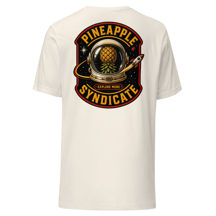 Pineapple Syndicate Explore More Signal tee featuring a space helmet with a floating pineapple inside, rocket detail, starfield backdrop, Explore More badge, and bold black, gold, and red framing.