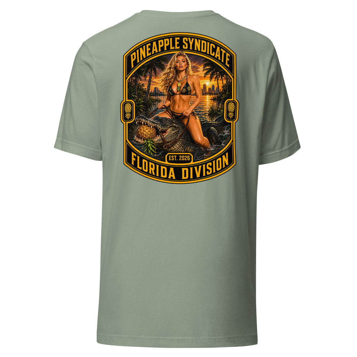 Pineapple Syndicate Florida Division tee featuring a blonde pinup riding an alligator through swamp water with an upside-down pineapple, sunset backdrop, and bold black-and-gold framing.