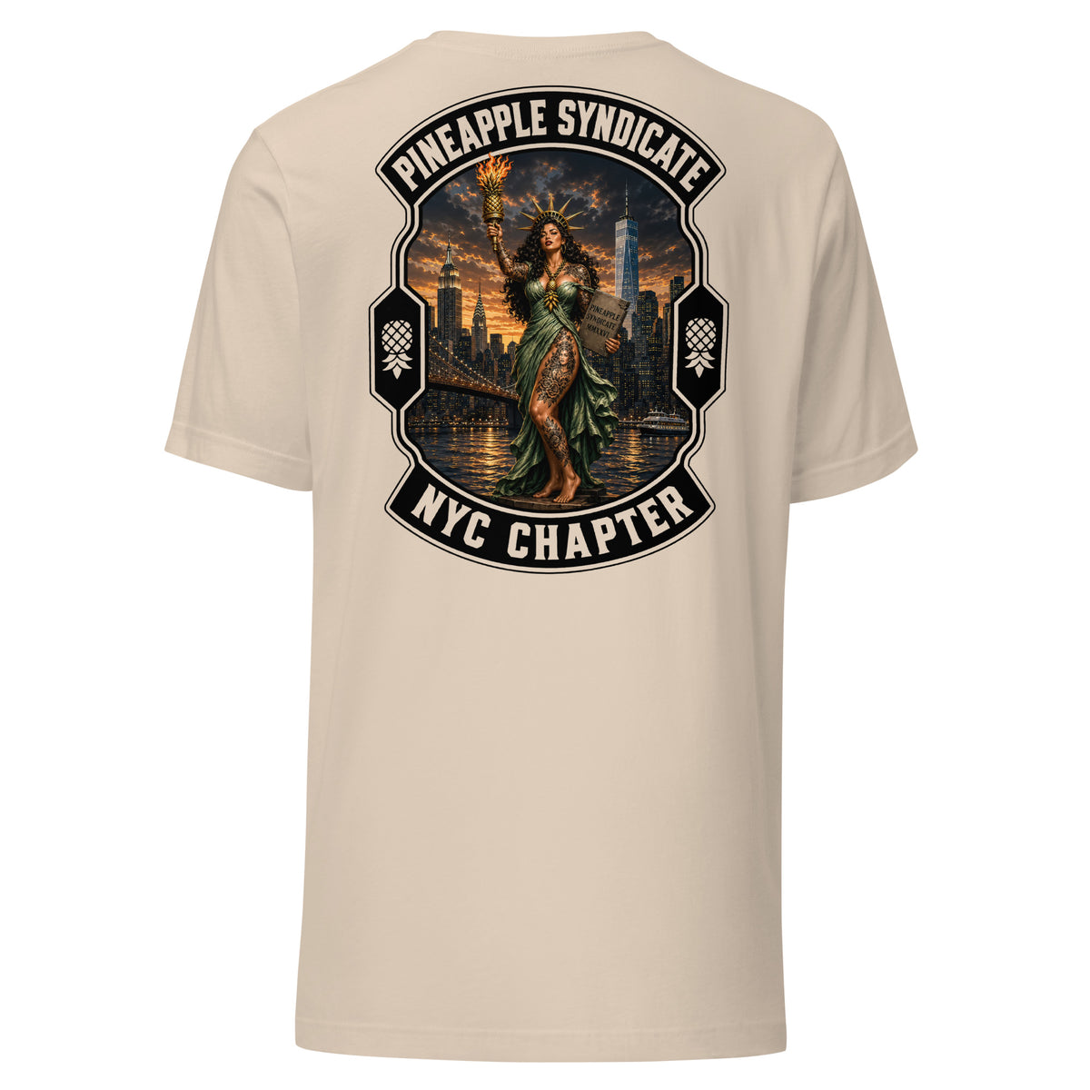 Pineapple Syndicate NYC Chapter tee featuring a Lady Liberty pinup holding a flaming pineapple torch with Manhattan skyline, waterfront lights, bridge scene, and bold black-and-cream framing.