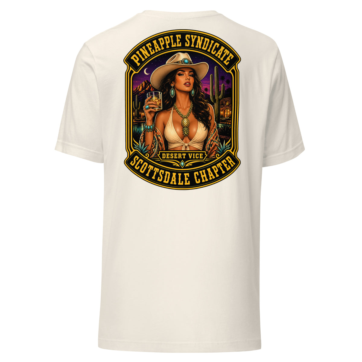 Pineapple Syndicate Scottsdale Chapter tee featuring a pinup in a cowboy hat with whiskey glass, desert skyline, cacti, and bold black-and-gold framing.