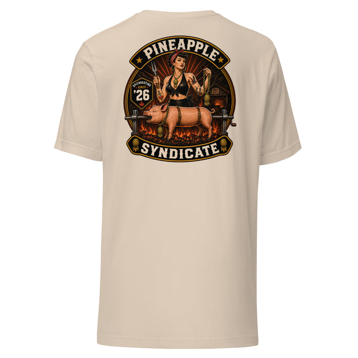 Pineapple Syndicate Spitroasting Since ’26 tee featuring a retro pinup with grilling fork, spit-roast pig scene, hot-pit backdrop, pineapple chain details, and bold black, cream, and red framing.