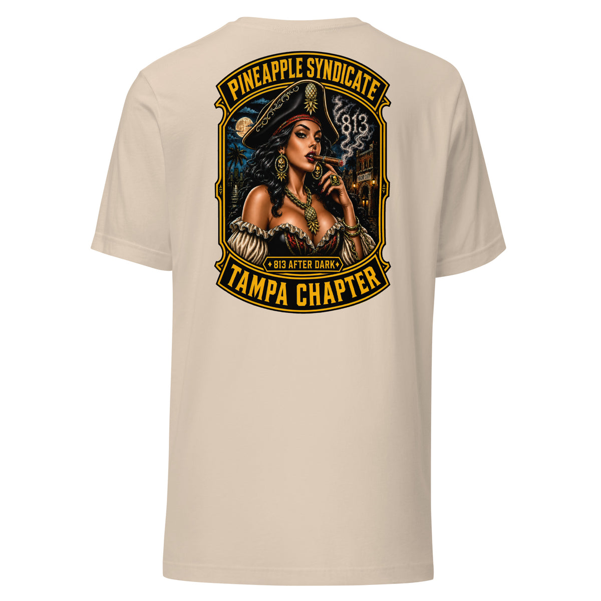 Pineapple Syndicate Tampa Chapter tee featuring a pirate pinup smoking a cigar, smoke-formed 813, Ybor City backdrop, moonlit skyline, and bold black-and-gold framing.