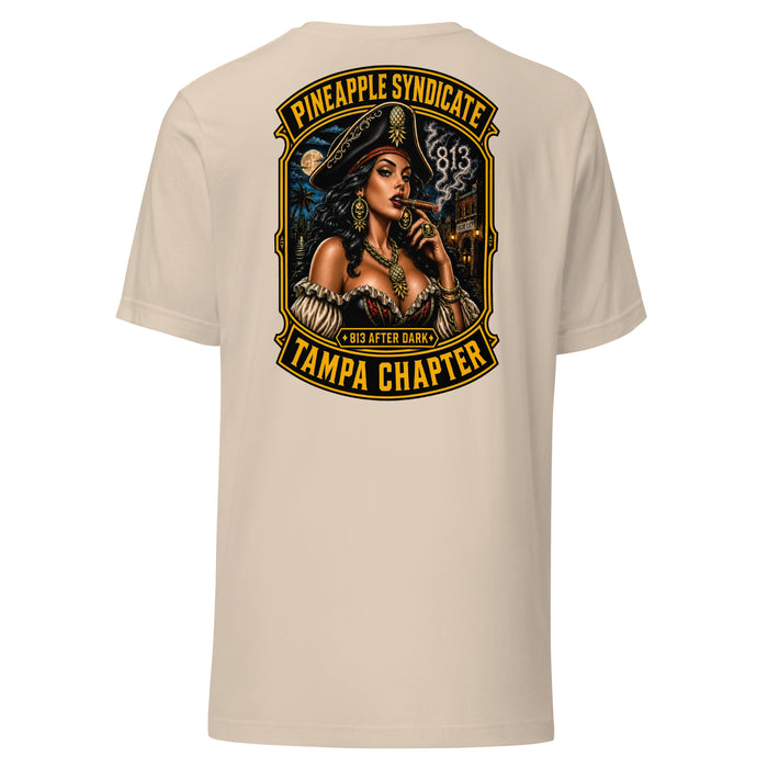 Pineapple Syndicate Tampa Chapter tee featuring a pirate pinup smoking a cigar, smoke-formed 813, Ybor City backdrop, moonlit skyline, and bold black-and-gold framing.