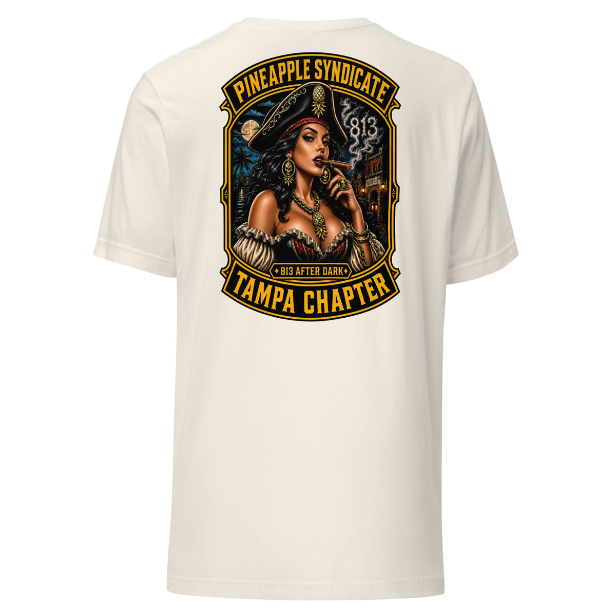 Pineapple Syndicate Tampa Chapter tee featuring a pirate pinup smoking a cigar, smoke-formed 813, Ybor City backdrop, moonlit skyline, and bold black-and-gold framing.