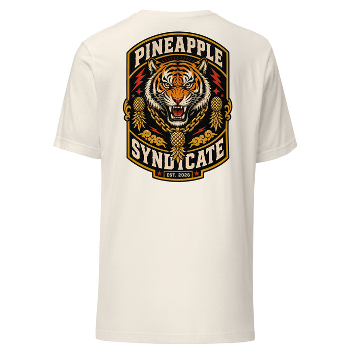 Pineapple Syndicate Tiger Signal tee featuring a roaring tiger with a gold pineapple chain pendant, pineapple side icons, red lightning accents, and bold black-and-cream framing.