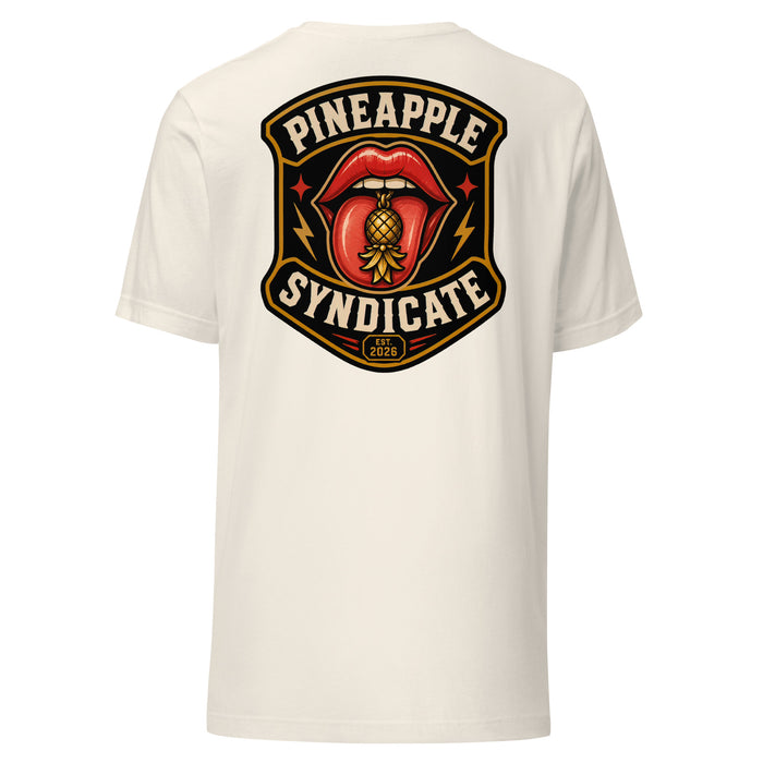 Pineapple Syndicate Quiet Signals tee featuring glossy red lips with a gold pineapple tongue charm, lightning-bolt accents, Est. 2026 badge, and bold black-and-cream framing.